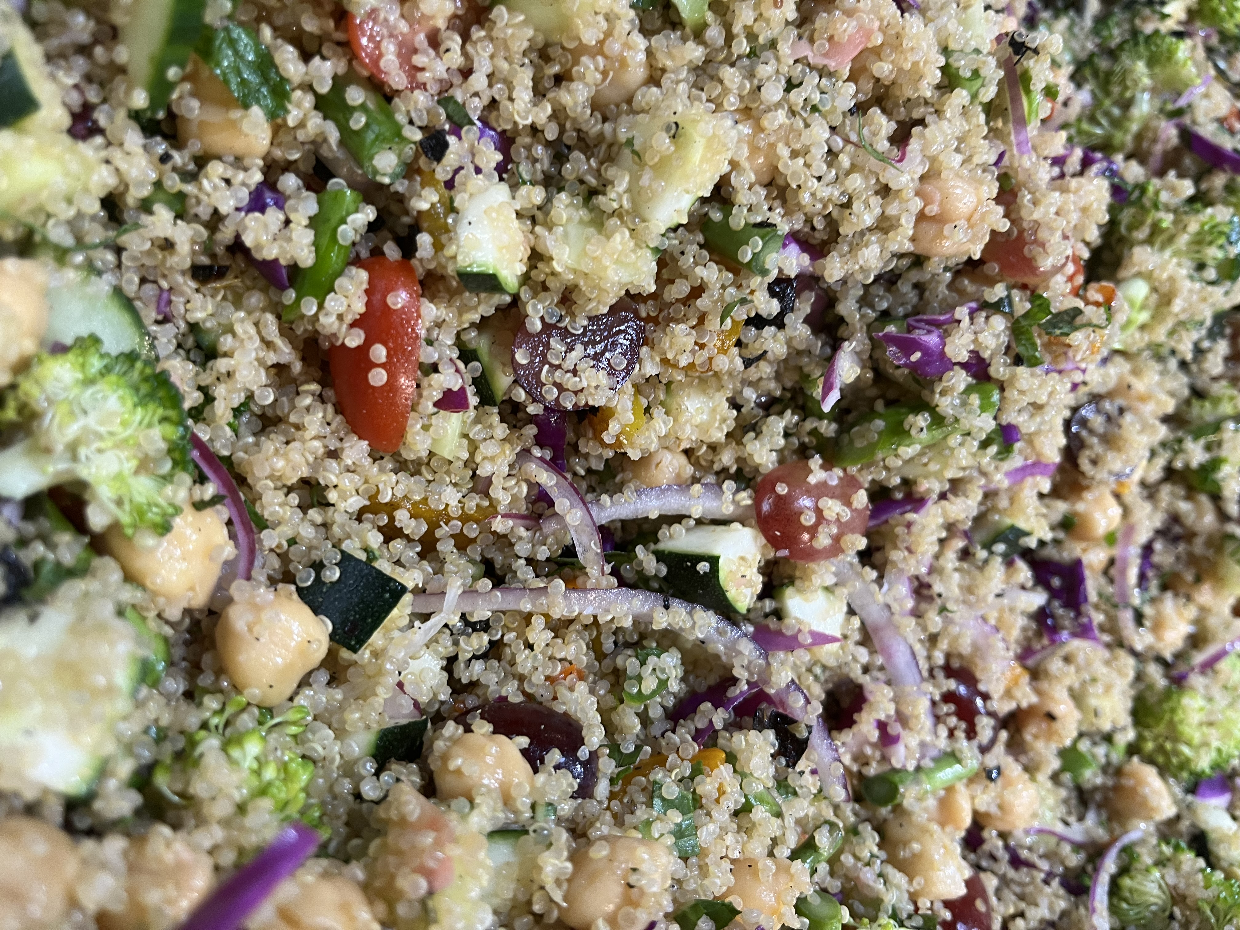 Overhead quinoa salad with charred vegetables and herbs